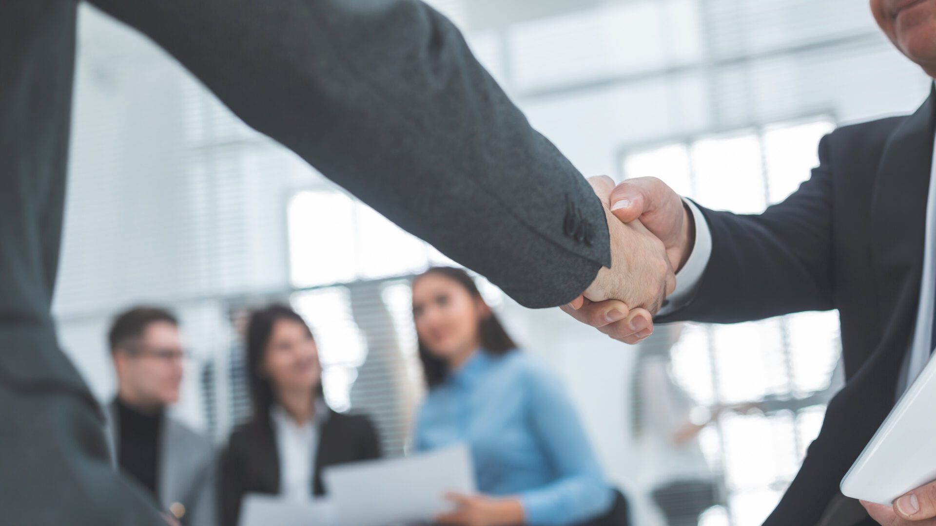 close up. handshake of business partners in the background of the office. concept of cooperation